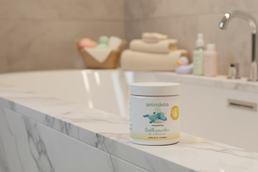 Aromama salt powder container on a bathroom counter with bath products in the background.