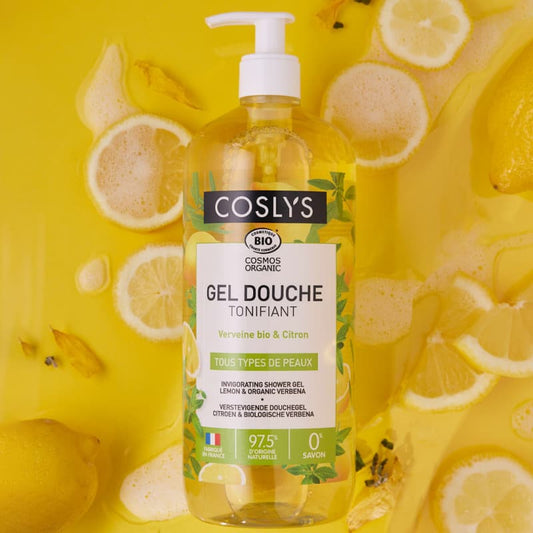Coslys shower gel bottle with lemons on a yellow background